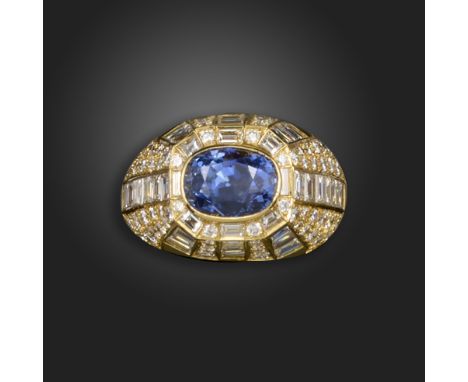 A sapphire and diamond dress ring, set with an oval-shaped sapphire, the high-domed gold ring set with round brilliant-cut an