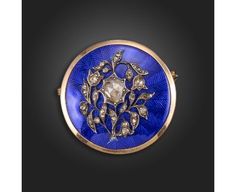 An early 19th century diamond and enamel circular locket brooch, applied with a rose-cut diamond-set foliate motif in silver 