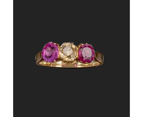 A ruby and diamond three-stone ring, the old cushion-shaped diamond is set with a cushion-shaped ruby to each shoulder in gol