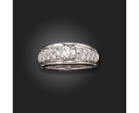 A diamond half hoop ring by Boucheron, set with an oval shaped diamond within shoulders set with graduated round brilliant-cu