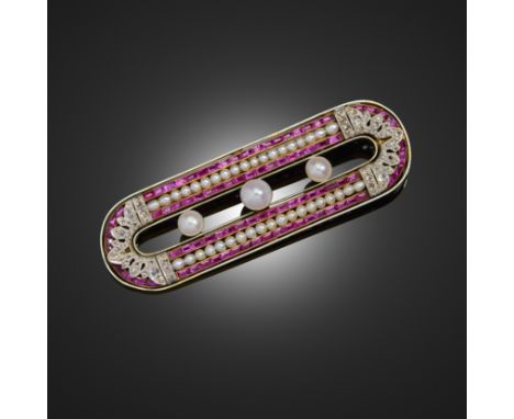 An early 20th century natural pearl, ruby and diamond brooch by Chaumet, the oval brooch centred with three natural pearls wi