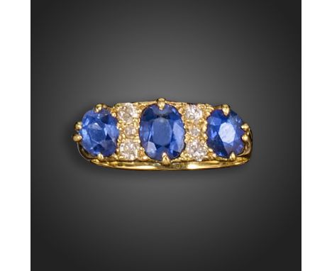 A late Victorian sapphire and diamond half-hoop ring, set with three graduated cushion-shaped sapphires between rows of old c