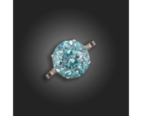 An early 20th century zircon and diamond ring, the circular-cut blue zircon is set with three single-cut diamonds to each sho