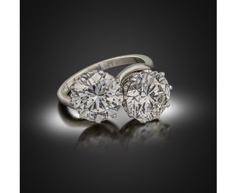 A diamond two-stone crossover ring, the two transitional round brilliant-cut diamonds weigh 3.85 and 4.09cts, in coronet plat