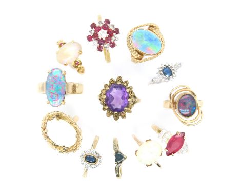 Twelve gem-set gold rings, including an opal cabochon-mounted gold ring, a ruby and diamond cluster ring, and various other g