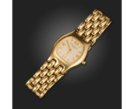 A lady's 18ct gold wristwatch by Patek Philippe, the signed tonneau-shaped face with white enamel dial, gold hands and Roman 