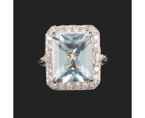 An aquamarine and diamond cluster ring, the rectangular mixed-cut aquamarine weighs approximately 7.50cts, set within a surro