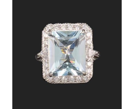 An aquamarine and diamond cluster ring, the rectangular mixed-cut aquamarine weighs approximately 7.50cts, set within a surro