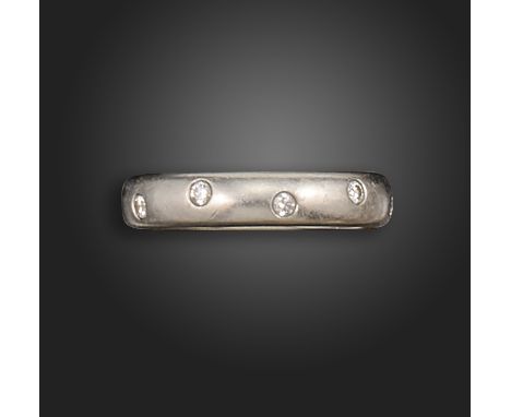 A diamond wedding band by Tiffany &amp; Co., set with ten round brilliant-cut diamonds in an undulating pattern in platinum, 