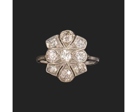 A diamond cluster ring, of quatrefoil design, set with old circular-cut diamonds in platinum, size P