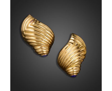 A pair of lapis lazuli-set gold earrings by Boucheron, of abstracted fluted design and set with a lapis lazuli cabochon in go