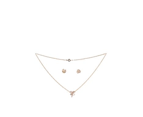 A diamond pendant with matching ear studs, the pendant designed as a clover with four pear-shaped diamond leaves, smaller dia