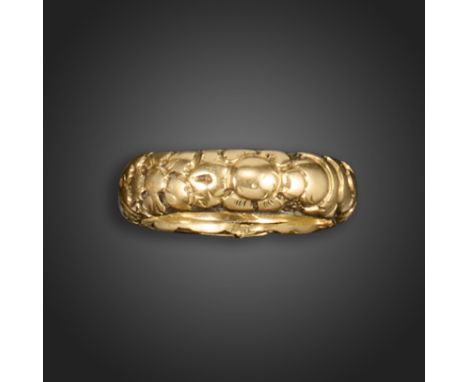 An early 19th century gold mourning ring, with foliate repoussι decoration and a secret (vacant) locket compartment to interi