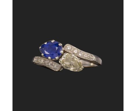 A sapphire and diamond 'toi-et-moi' ring, early 20th century, of crossover design, the ends set with a pear-shaped sapphire a