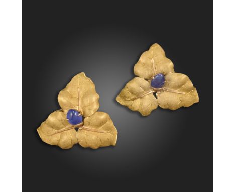 A pair of sapphire-set gold earrings by Buccellati, c.1970s, each centred with a carved sapphire amongst a trefoil of texture