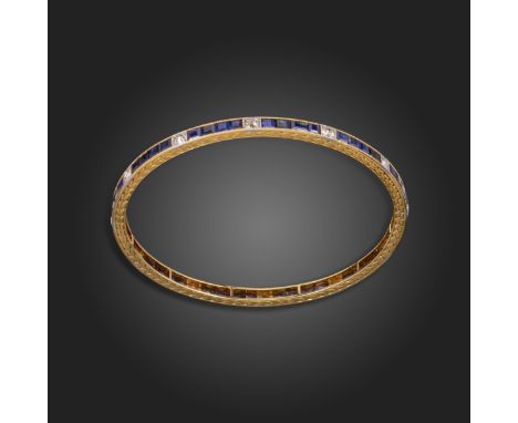 A sapphire and diamond bangle, alternately-set with calibre-cut sapphires and old circular-cut diamonds in gold and platinum,