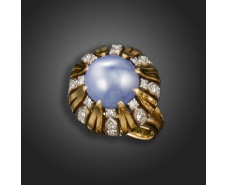 A star sapphire and diamond ring, set with a circular star sapphire cabochon, the openwork surround alternately-set with sing