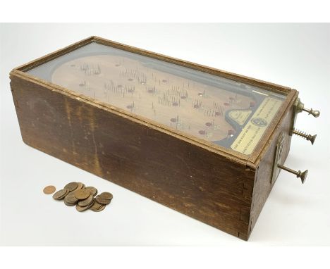 Early 20th century table top bagatelle game 'The Advance Pin Table - British Made - For Amusement Only',  in oak case with gl