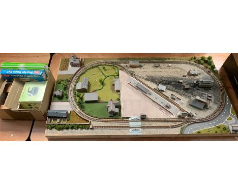 'N' gauge - wooden table-top layout of oblong form the central loop of track with sidings, station, engine shed and other bui