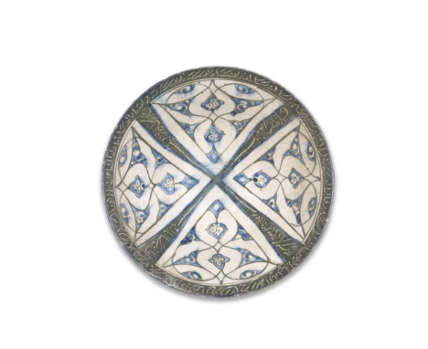 A Kashan underglaze-painted pottery bowl Persia, 12th/ 13th Centuryof conical form on a long foot, decorated underglaze in co