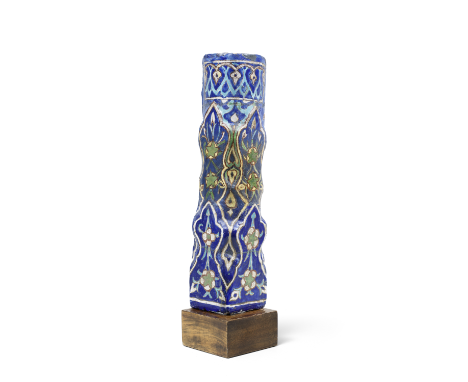 A Timurid moulded cuerda seca pottery tile Persia, circa 1450of convex form with two rows of moulded palmettes surmounted by 