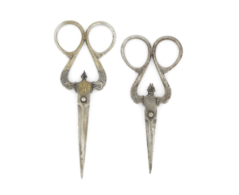 Two pairs of Qajar steel scissors Persia, 18th/ 19th Centuryeach with large serpentine handles terminating in dragon heads, p