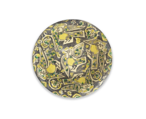 A Nishapur buffware pottery bowl Persia, 10th Centuryof shallow rounded form on a short foot with everted rim, decorated unde