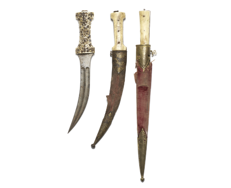 Three walrus ivory-hilted steel daggers North India and Persia, 19th Centurycomprising a Qajar jambiyya, the hilt with traces