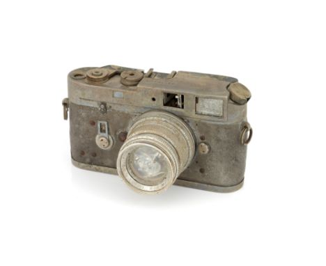 A Fire Damaged Leica M4 Rangefinder Camera, 1968, chargrilled, serial no. 1212659, with Leitz Summicron f/2 50mm lens, 1968, 