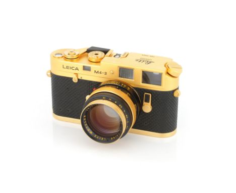 A Leica M4-2 Gold Rangefinder Camera, 1979, gold, serial no. 1527314, with Leitz Summilux f/1.4 50mm lens, 1977, gold, serial