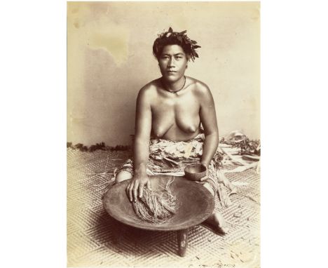 A Photograph of a Solomon Islands Woman, albumen print, c.1880, illustrating food preparation, 20cm x 14.5cm, unmounted