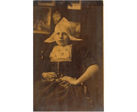 An Impressive Carbon Print Photograph on Wood, Dutch school, a young woman in traditional costume, c.1900, 43cm x 27cm