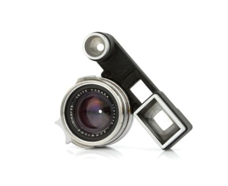 A Leitz Summilux f/1.4 35mm 'Steel Rim' Lens, 1960, with ocular attachment, chrome, serial no. 1765239, body, VG, elements, G