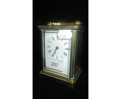A BRASS CARRIAGE CLOCK, with white enamel dial
