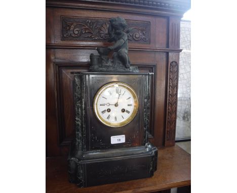 A 19TH CENTURY SLATE-CASED MANTEL CLOCK, decorated with a cherub on top, heating an arrow on an anvil (key in office)