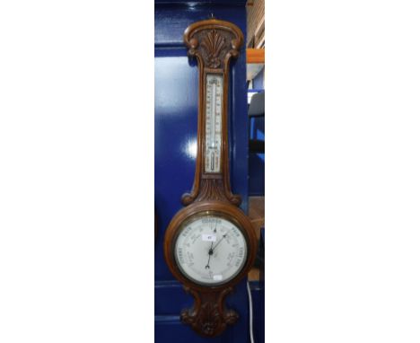 AN EARLY 20TH CENTURY CARVED OAK BAROMETER/THERMOMETER, 36"