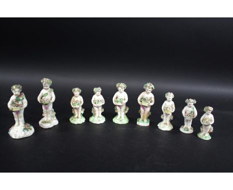 DERBY PORCELAIN &amp; OTHER CHERUB FIGURES 18 various cherub figures, each holding a bowl of flowers or nest of birds. Includ