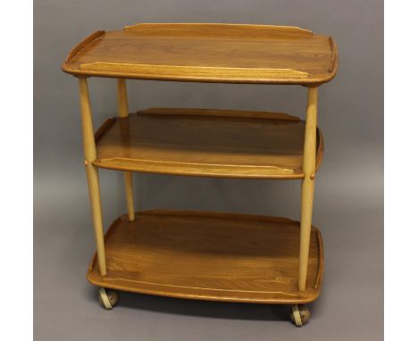 ERCOL TEA TROLLEY Model No 458, a three tier light elm and beech tea trolley, supported on castors. 78cms high