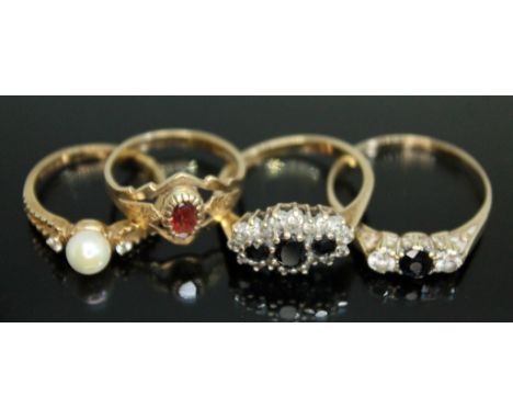 Four hallmarked 9ct gold rings, various settings and stones, gross weight 7.38g, sizes J, K, P &amp; S.  