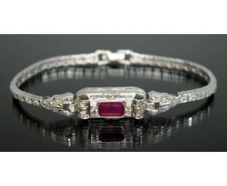 An Art Deco style diamond and ruby bracelet, the emerald cut ruby weighing approx. 4.50 carats, total approx. diamond weight 