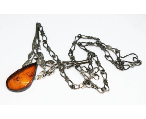 A continental white metal Art Nouveau style amber pendant, marked '800'.  