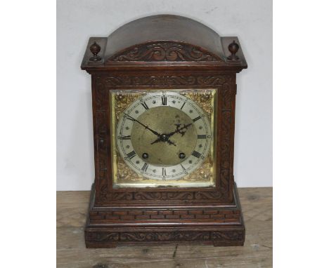 A carved oak mantel clock, circa 1900, striking on double gong, height 33cm.  