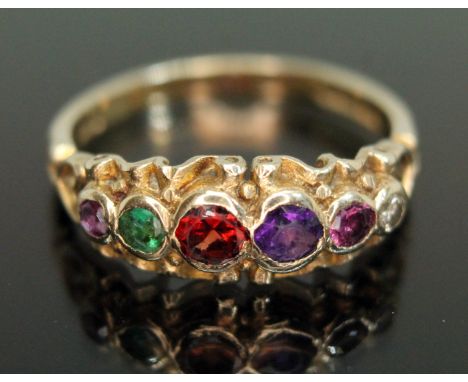 A multi-gemstone ring set with a diamond, two rubies, a garnet, an amethyst and and emerald, chosen to spell out "REGARD", ha