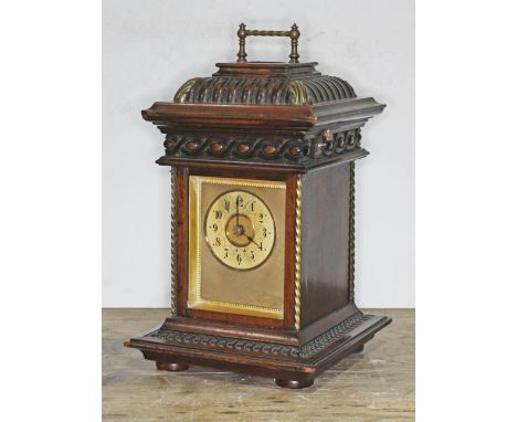 A late 19th century carved oak mantle clock, the top with hinged lid revealing a polyphon music player with a single 4 1/2" d