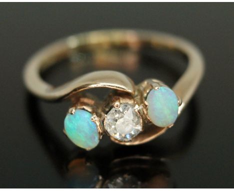 A diamond and opal ring, the central Old European cut diamond weighing approx. 0.22 carats, band indistinctly marked '18ct', 