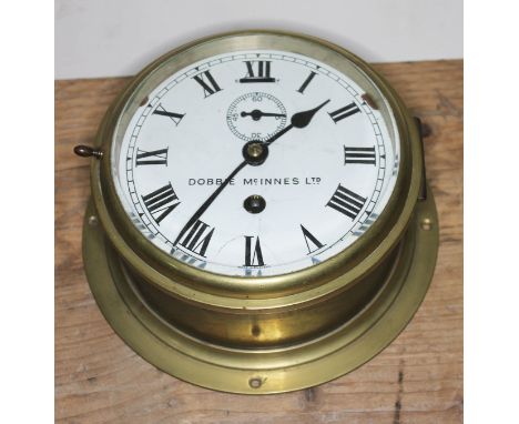 A ship's bulk head clock signed Dobbie McInnes, diameter 20.5cm.  