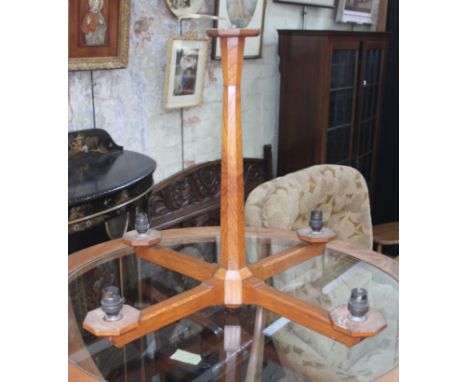 A Cotswold or Lakeland school oak light fitting.Dimensions:- 49cm high, 60,5cm width.