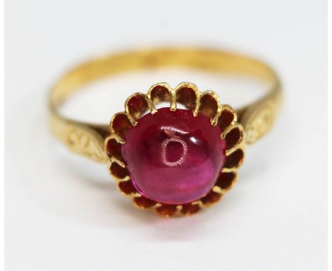 An eastern yellow metal ring set with a ruby cabochon weighing approx. 2.75 carats, band unmarked, gross weight 3.17g, size O