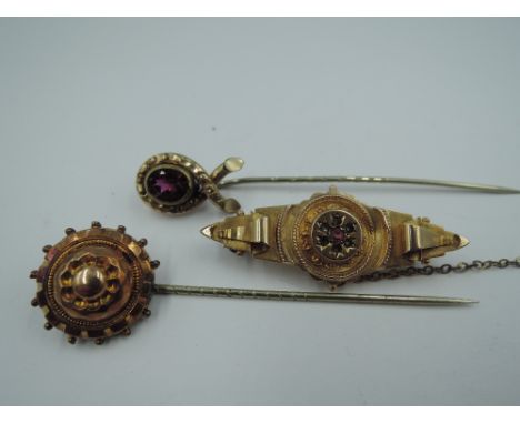 Two yellow metal stick pins and a brooch stamped 9ct, approx 7.6g