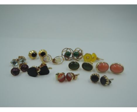 Eleven pairs of yellow metal stud earrings of various forms including, coral, opal, etc, approx 13.7g